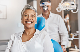 Woman smiling while sitting in treatment chair